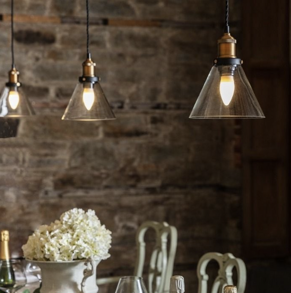 Glass pendant lights positioned above a dining table